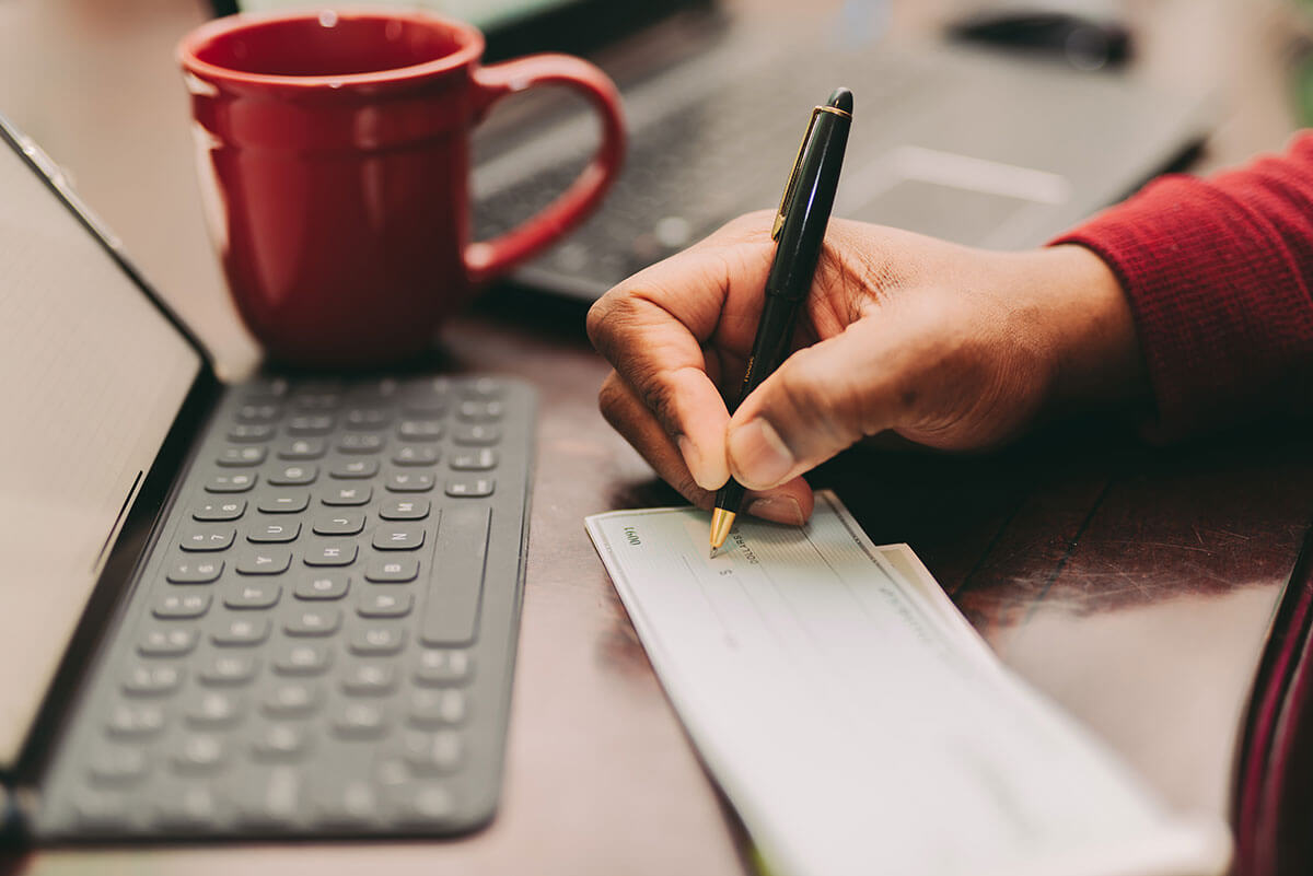 writing a check at a computer
